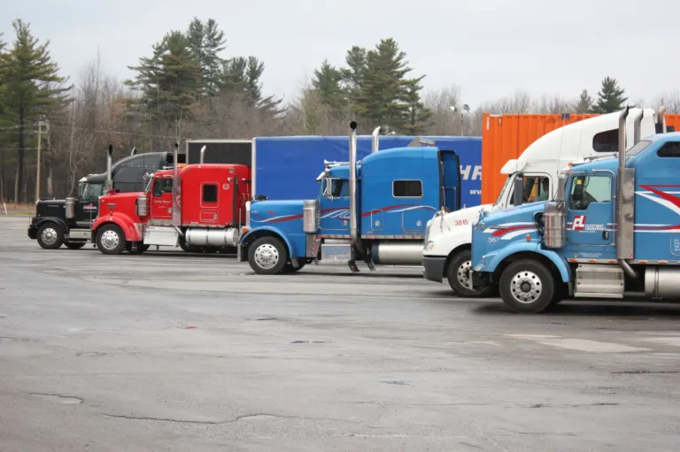 Semi trucks parked in an open lot